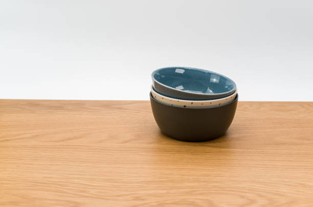 istock colorful piled up empty stoneware bowls on a wooden tabletop with copy space 1454537227
