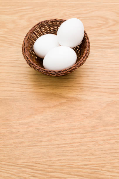 istock white eggs in a wicker canister on a wooden background 1454537575