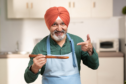 Mature Sikh Man With Turban In a Kitchen, stock photo