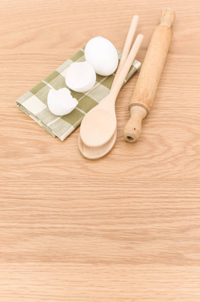 istock natural solid wood kitchen tools and table napkin with eggs on a wooden background 1454540474