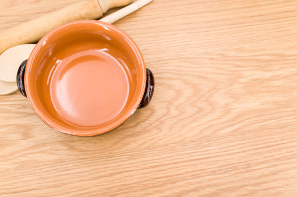 istock rustic terracotta bowl and natural solid wood kitchen tools on a wooden tabletop 1454540664