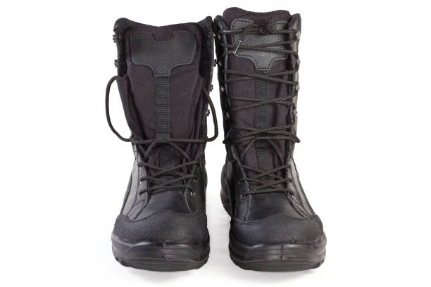 istock Pair of black high top leather combat boots, front view 1454541737