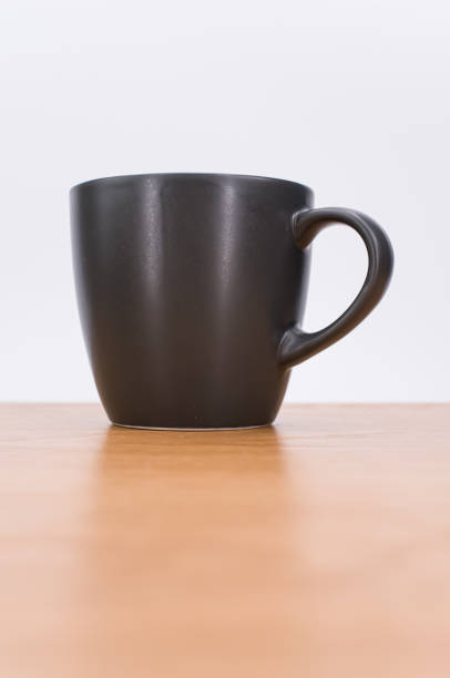 istock isolated empty stoneware mug on a wooden tabletop with text space 1454542228