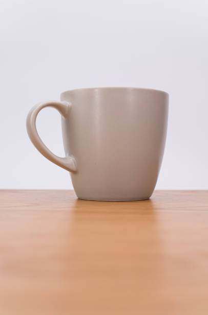 istock isolated empty stoneware mug on a wooden tabletop with text space 1454542229