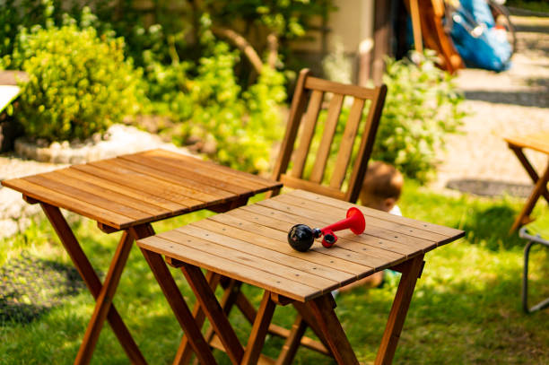 istock Red bicycle horn on a wooden table in a garden 1454542975