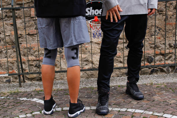 Two models wearing fashionable black Air Jordan shoes and for a photoshoot Padova, Italy – November 16, 2016: The two models wearing fashionable black Air Jordan shoes and for a photoshoot nike air photos stock pictures, royalty-free photos & images