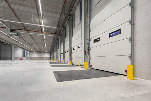 istock Interior of a new empty warehouse with loading docks ready to be used 1454545175