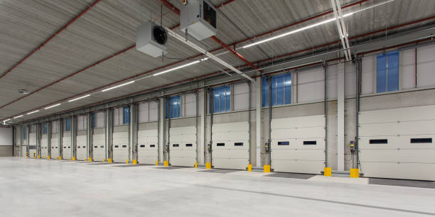 istock Interior of a new empty warehouse with loading docks ready to be used 1454545181