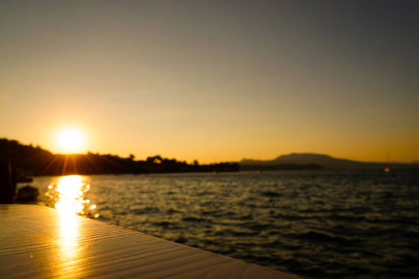 After a relaxing day in Koroni one gets to view the sunset and its reflections in the water from the table of a restaurant