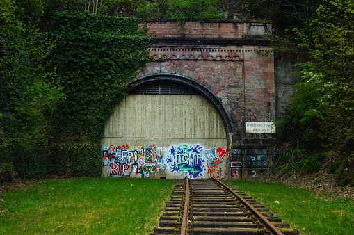 Eppstein, Germany – May 09, 2021: The old tunnel in Eppstein, Taunus, on the Main-Lahn railway. It was replaced by a new tunnel next to it. Today a habitat for bats, open at the top.
