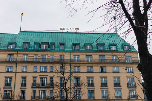 Berlin, Germany – November 27, 2021: Building of the famous Hotel Adlon in Berlin. Photo of the building on which the hotel name is written on a sign. Many films were shot here.
