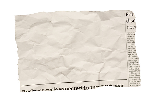 Piece of paper torn from a simulated newspaper, designed by the photographer and free of design copyright. Large blank area in which to insert your copy. Isolated on white.