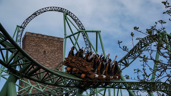 Sierksdorf, Germany – April 30, 2022: Young people have fun during a ride at Hansapark roller coaster \