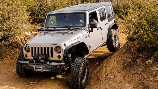 Woodland Hills, United States – May 20, 2022: An off-road Axel Flex Silver jeep on the Miller Keep trail in Woodland Hills