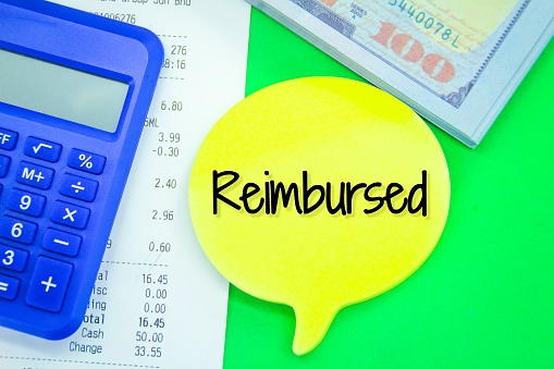 calculators, banknotes, receipts and conversation boxes with the word reimbursed Concept