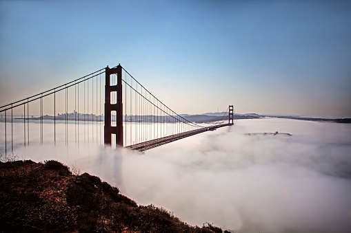 A beautiful view of the Golden Gate Bridge in white fluffy clouds, San Francisco, USA