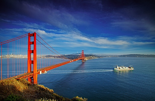 A beautiful scene with the majestic Golden Gate Bridge and a sailing boat, San Francisco, USA