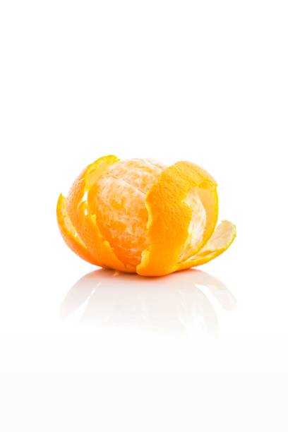 istock Vertical shot of an orange with its peeling on a white background. 1454551396