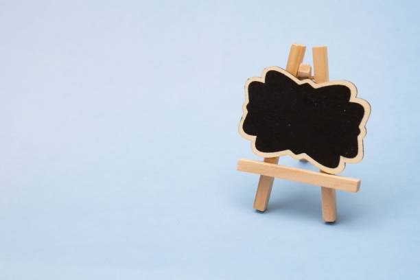 istock Blackboard for your own message on a wooden easel isolated on blue background 1454553249