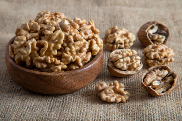 istock Peeled walnuts and whole walnuts on burlap sack 1454554545