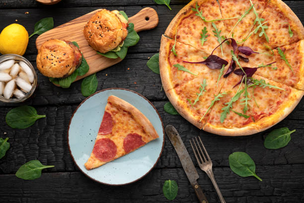 Italian pizza with one slice on wooden table. Italian Pizza Manzo.