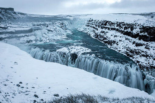 A beautiful scene of white Gullfoss Falls Waterfall in Iceland in winter