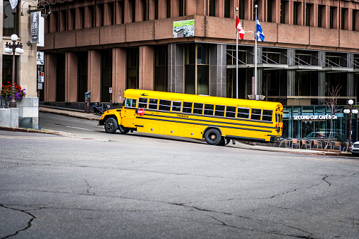 Québec City, Canada - August 22, 2022: school bus on a road. Québec City is the capital of the largely French-speaking Canadian province of Québec.