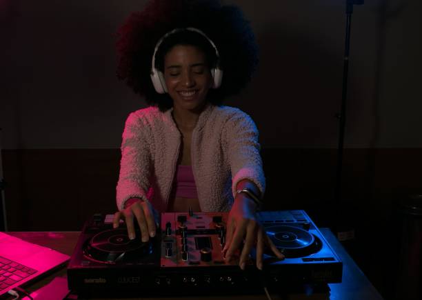istock Young woman DJ playing music 1454559148