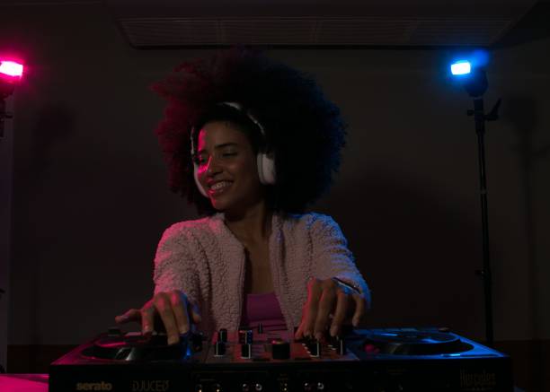 istock Young woman DJ playing music 1454559152