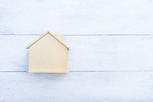 istock Wooden house model with space on white wood background 1454559343