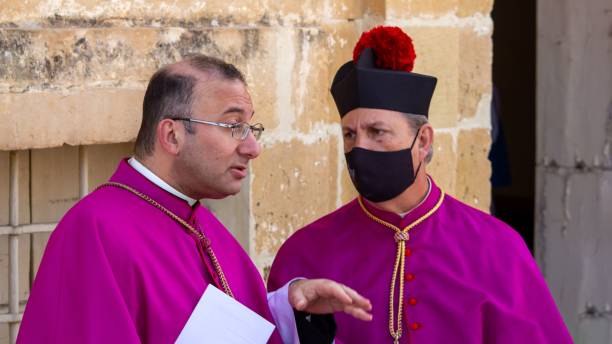 Monsignors discussing an important issue outside of a church in Malta Zejtun, Malta – April 20, 2022: Two Monsignors discussing an important issue outside of a church in Malta monsignor stock pictures, royalty-free photos & images