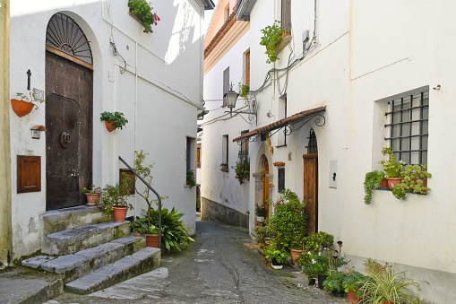 A scenic view of a narrow street and old houses in Aieta village, the Calabria region, Italy