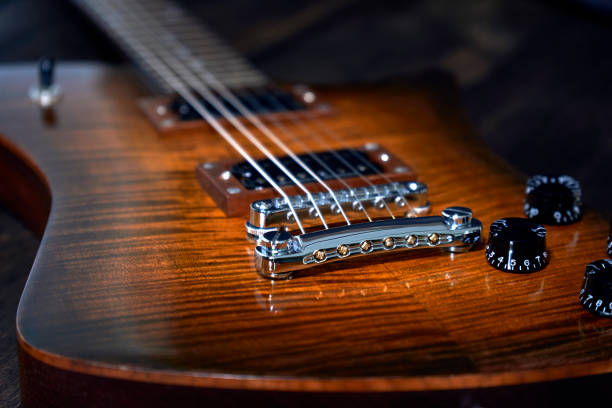istock Closeup of the potentiometer knobs on the guitar. 1454560239