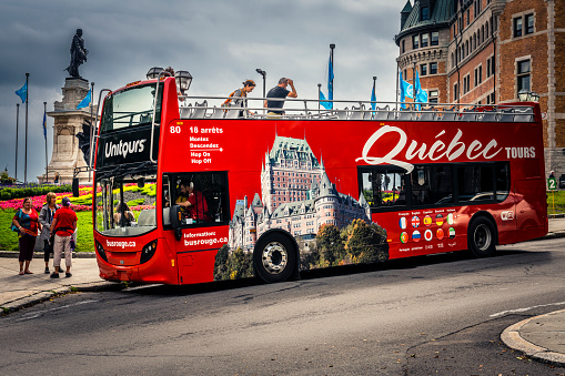 Québec City, Canada - August 22, 2022: sightseeing bus with tourists. Québec City is the capital of the largely French-speaking Canadian province of Québec.