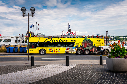 Québec City, Canada - August 22, 2022: sightseeing bus with tourists. Québec City is the capital of the largely French-speaking Canadian province of Québec.