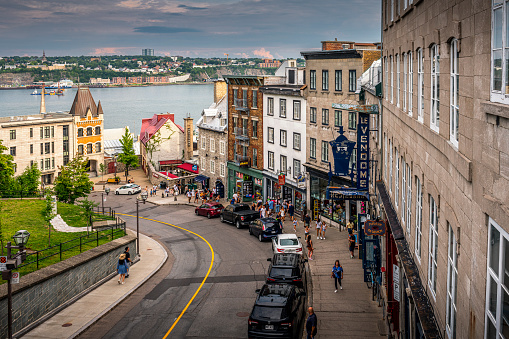Québec City, Canada - August 21, 2022: A shopping street and Saint Lawrence river in background in Québec City in Canada. Québec City is the capital of the largely French-speaking Canadian province of Québec.