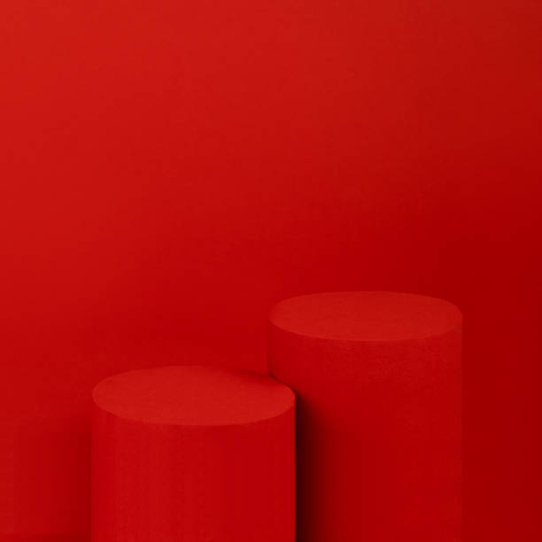 istock Festive elegant saturated red stage with two cylinder podiums for presentation cosmetic products, gifts, goods in luxury modern style, copy space, square. Template for advertising, design, card. 1454563292