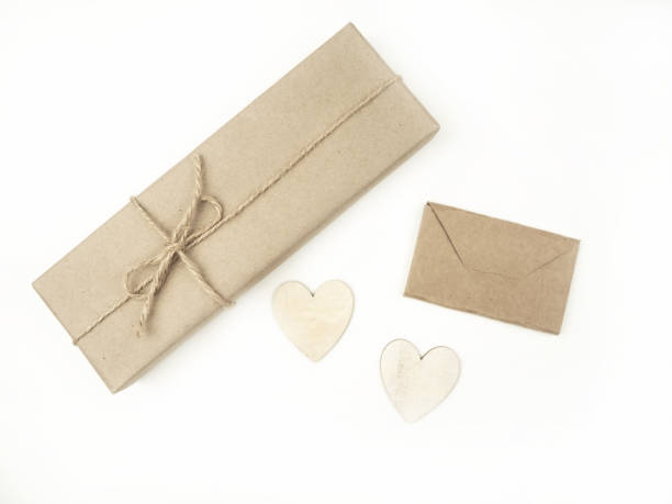 istock Gift box wrapped in kraft paper on a light background. Holiday concept. Valentine's Day. Gift. 1454563557