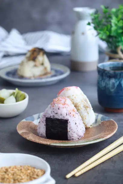 Photo of A plate of traditional Japanese rice ball (Onigiri) with chopsticks