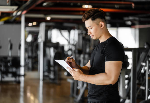 istock man writing paper in gym room 1454564511