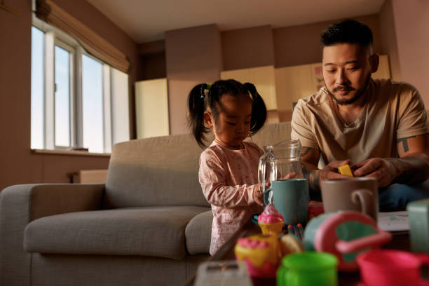 istock Father and daughter playing with utensils and toys 1454564855