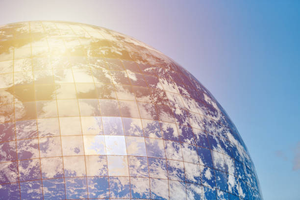 istock Earth planet modern building with clouds and blue sky in sunlight, ecological architectural concept 1454565221