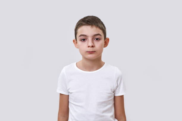 istock Front view of serious little boy looking at camera 1454566097