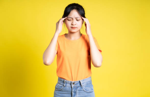 istock Asian girl posing on yellow background 1454566235