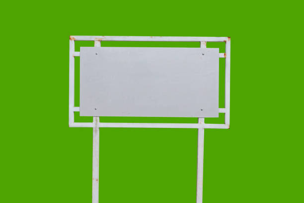 istock Realistic white traffic sign on two metal poles isolated on green background. Rectangular blank traffic road empty sign. Mock up template for your design. 1454566562
