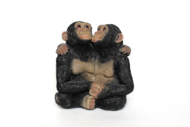 istock antique statuette of two cuddling monkeys on a white background 1454567237