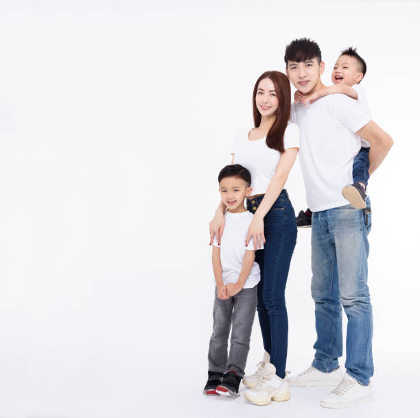 istock Happy Asian family standing together on white background 1454568558
