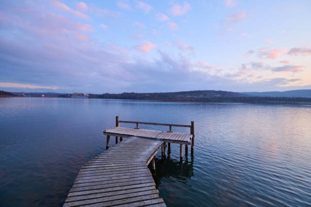istock Wooden jetty on lake at sunset 1454568611