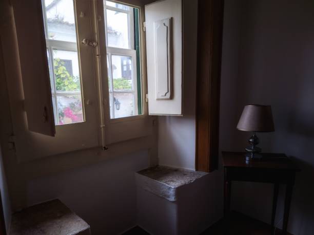 istock Interior of the room with shadows and a small window 1454571416