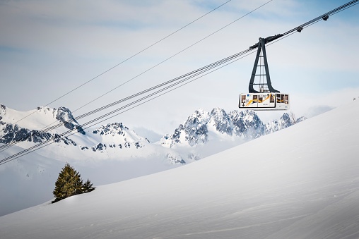 Vaujan, France – March 15, 2020: View of the lift surrounded by snow at Oz en Oisans near Alpe d'Huez at Vaujany resort, France